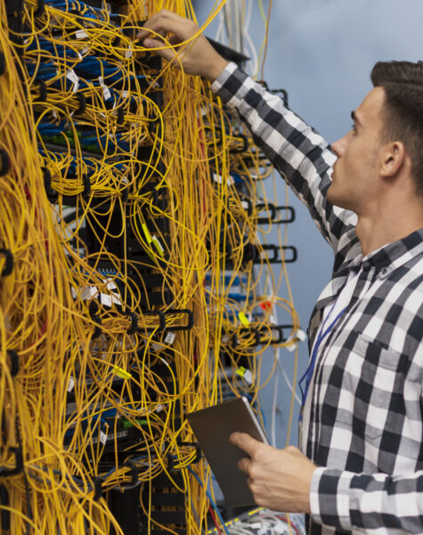 young-network-engineer-working-server-room